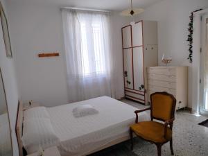 a bedroom with a bed and a chair and a dresser at L'antica Terrazzella in Vasto
