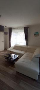 a living room with a white couch and a coffee table at Juliusruh Strandparadies 1 in Juliusruh