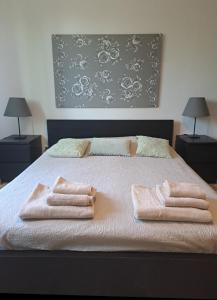 a bedroom with a bed with two towels on it at Vistamare in Marina di Cecina