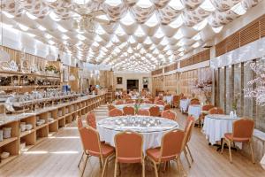a dining room with tables and chairs and ceilings at Du Parc Hotel Dalat in Da Lat
