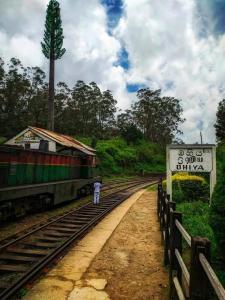 a man walking on the tracks next to a train at Horton Mountain in Ohiya