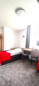 a bedroom with a bed and a table and chairs at Noclegi Sezam in Łańcut