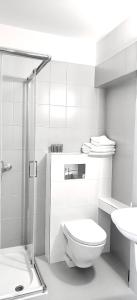 a white bathroom with a toilet and a sink at Noclegi Sezam in Łańcut