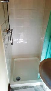 a bathroom with a bath tub and a sink at Hathway House Accommodation in Redhill