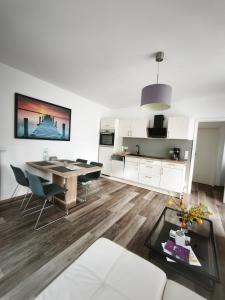 a kitchen and living room with a table and chairs at Juliusruh Strandparadies 1 in Juliusruh +10 photos