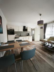 a kitchen and living room with a table and chairs at Juliusruh Strandparadies 1 in Juliusruh