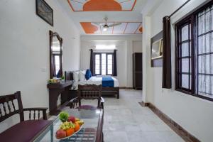 a room with a dining table and a bedroom at Hotel Royal Prithvi Palace Near Ghaziabad Railway Station in Ghaziabad