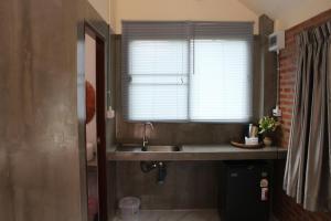 a bathroom with a sink and a window at MatanaCafe&Resort in Ban Bo Nam Khao +13 photos