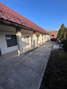 a building with a red roof and a driveway at Casa Boitor in Jidvei