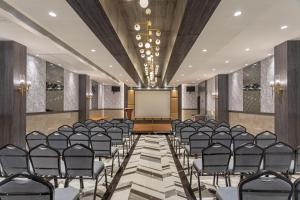 a conference room with chairs and a projection screen at Hill Berry - A SoVo Hotel in Lonavala +48 photos