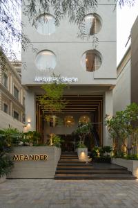a store front of a manier building with a staircase at MEANDER Saigon in Ho Chi Minh City +51 photos
