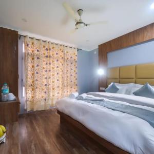 a bedroom with a large bed and a window at Hotel Your Hive in Srinagar
