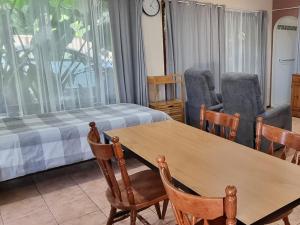 a room with a table and chairs and a bed at Theme Park Getaway in Gold Coast