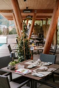 a wooden table with chairs in a restaurant at Hotel Sonnegg in Saalbach-Hinterglemm