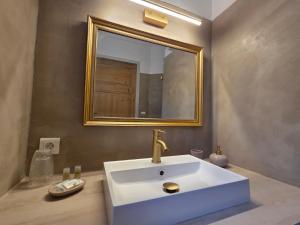 a bathroom with a white sink and a mirror at Domaine Les Gendalis in Saint-Saturnin-les-Avignon +38 photos