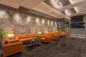 a lobby with orange chairs and a waiting room at Hill Berry - A SoVo Hotel in Lonavala