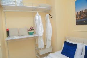 a bedroom with a bed and a shelf with towels at Executive-Studio-Apartmen in Nairobi +23 photos