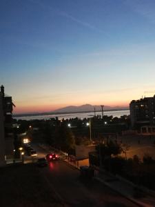 a view of a city at night with a sunset at Blue Horizon SKG in Thessaloniki