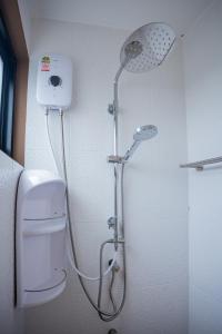a shower with a shower head in a bathroom at Vera Cozy Stay 2 in Ban Zong Katiam +31 photos
