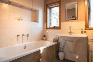 a bathroom with a bath tub and a sink at Wildeston in Thurso +36 photos