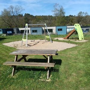 a park with a picnic table and a playground at ZEcamping 3 étoiles animaux acceptés piscine et restaurant in Pluherlin