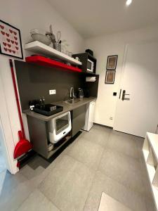 a small kitchen with a sink and a microwave at LH Apartments Aulendorf in Aulendorf