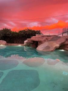 a pool of water with a sunset in the background at Cambrils Paradise in Cambrils
