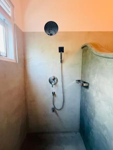 a shower with a shower head in a bathroom at Villa Mario in Unawatuna +5 photos