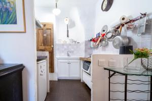 a small white kitchen with a table in it at Le petit carnot in Apt