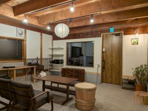 a living room with a table and a television at とまり木 in Yoshino