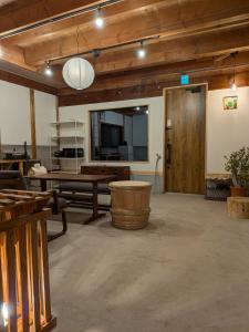 a large living room with a table and a bench at とまり木 in Yoshino