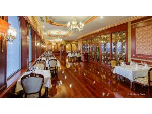 a restaurant with tables and chairs in a room at Meyra Palace in Ankara