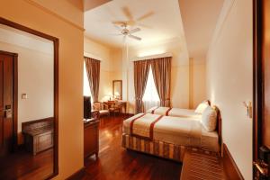 a hotel room with a bed and a mirror at Du Parc Hotel Dalat in Da Lat +53 photos