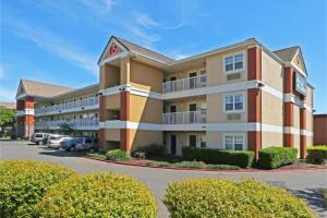 a hotel building with cars parked in a parking lot at Studio 6 Suites Sacramento Northgate CA in Sacramento