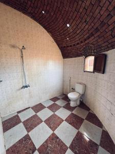 a bathroom with a toilet and a tiled floor at Dana beach camp in Nuweiba