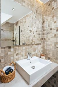 a bathroom with a sink and a mirror at Morfeas Hotel in Chania +68 photos