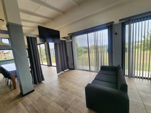 a living room with a couch and a table at Cabañas Kai Rau Tu in Hanga Roa