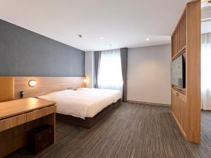 a hotel room with a bed and a flat screen tv at SUPER HOTEL HANOI - Grand Opening in 17 March 2026 in Hanoi +126 photos