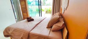 a bedroom with a bed with a teddy bear on it at Samma Villas - Agate Villa - 1 BDR & private pool in Ko Phangan +19 photos
