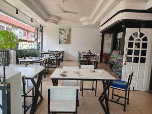 a restaurant with tables and chairs in a room at QG restaurant and guesthouse in Hua Hin