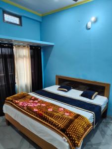 a bedroom with a large bed with flowers on it at Shri Janki Raman kunj 5 minut from ram mandir in Ayodhya +11 photos