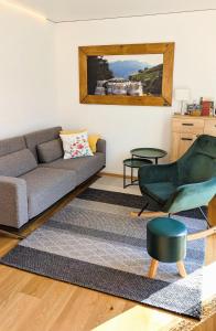 a living room with a couch and a chair at Ferienhaus Haus im Garten in Feldkirch