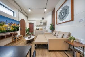 a living room with a couch and a table at Swing By in Bangkok