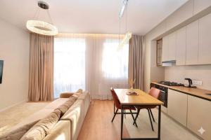 a living room with a large couch and a table at MONACO House in Chişinău