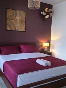 a bedroom with a large bed with two towels on it at Stars Villa in Ngingas +66 photos