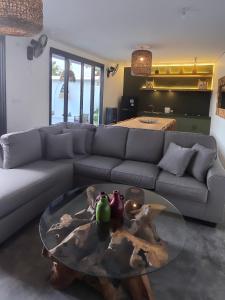 a living room with a couch and a glass table at Stars Villa in Ngingas