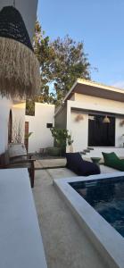 a backyard with a swimming pool and a house at Stars Villa in Ngingas