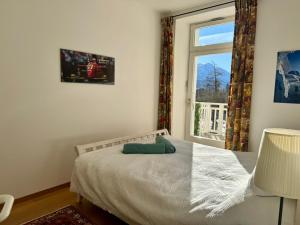 a bedroom with a bed and a window at Vache Mystique in Orsières +38 photos