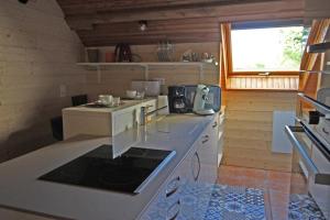 a kitchen with a stove and a counter top at Rosalie in Masléon
