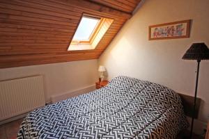 a bedroom with a bed in a room with a window at Rosalie in Masléon
